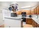 Eat-in kitchen features stainless appliances, light countertops and wood cabinetry at 2782 S Ceylon St, Aurora, CO 80013