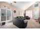 Bright living room with high ceilings, large windows, and comfortable black leather furniture at 2782 S Ceylon St, Aurora, CO 80013
