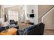 Inviting living room featuring large windows, a vaulted ceiling, and staircase to upper level at 2782 S Ceylon St, Aurora, CO 80013