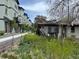Exterior view of new row houses next to a yard with wildflowers at 5375 W 60Th Ave, Arvada, CO 80003