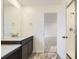 Bathroom featuring a sleek vanity, quartz counters, and a glass enclosed shower at 11030 Snowdon St, Parker, CO 80134