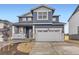Charming two-story home with a blue exterior, stone accents, and a spacious two car garage at 11030 Snowdon St, Parker, CO 80134
