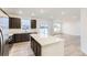 Open-concept kitchen featuring a center island, stainless appliances, and backyard views at 11030 Snowdon St, Parker, CO 80134