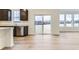 Contemporary kitchen with hardwood floors, dark cabinets, stainless steel dishwasher, and exterior access at 11030 Snowdon St, Parker, CO 80134