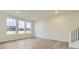 Bright living room with hardwood floors and large windows offering plenty of natural light at 11030 Snowdon St, Parker, CO 80134