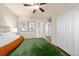 Bedroom with plush green bedspread, bedside tables, and closet at 1027 Koss St, Erie, CO 80516