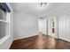 Neutral bedroom featuring hardwood floors, ample closet space, and natural lighting at 1027 Koss St, Erie, CO 80516