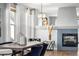 Bright dining room featuring a modern chandelier and sleek table with natural light at 1027 Koss St, Erie, CO 80516