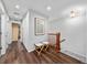 Well lit upstairs hallway with wood floors, coat hooks, and stairs to downstairs at 1027 Koss St, Erie, CO 80516