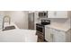 Bright, updated kitchen with stainless steel appliances, subway tile backsplash, and a sink with a goose-neck faucet at 50 S Boulder Cir # 5022, Boulder, CO 80303