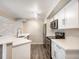 Modern kitchen with white cabinets, stainless steel appliances, and quartz countertops at 50 S Boulder Cir # 5022, Boulder, CO 80303