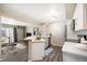 Well-lit kitchen with breakfast bar seating open to living room and balcony at 50 S Boulder Cir # 5022, Boulder, CO 80303