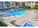 Aerial view of a sparkling community pool surrounded by lounge chairs and well-maintained landscaping at 50 S Boulder Cir # 5022, Boulder, CO 80303