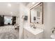 Finished basement bathroom near rec area includes a single vanity and framed mirror at 3549 Swabuck Pl, Castle Rock, CO 80109