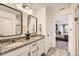 Beautiful bathroom features granite countertops, double sinks, modern fixtures and a view to the main bedroom at 3549 Swabuck Pl, Castle Rock, CO 80109