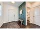 Inviting entryway featuring wood floors, a bench, a decorative mirror, and a half bathroom at 3549 Swabuck Pl, Castle Rock, CO 80109