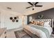 Comfortable main bedroom boasts stylish decor, a ceiling fan, and lots of natural light from a window at 3549 Swabuck Pl, Castle Rock, CO 80109