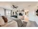 Bright main bedroom features a ceiling fan, comfortable sitting area, and a view into the ensuite bathroom at 3549 Swabuck Pl, Castle Rock, CO 80109