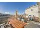 Inviting patio area with comfortable seating, an open wooden table, and scenic neighborhood views at 3549 Swabuck Pl, Castle Rock, CO 80109