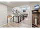 Bright entryway with staircase leads to an open floor plan living area at 17880 W 94Th Dr, Arvada, CO 80007
