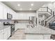 Bright kitchen features white cabinets, granite countertops, stainless steel appliances, and a spacious island at 17880 W 94Th Dr, Arvada, CO 80007