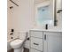 Bathroom with toilet, bathtub, and vanity with gray cabinets at 1885 Hickory Ave, Erie, CO 80516