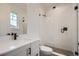 Modern bathroom with a glass shower, white subway tile, and gray floor tile at 1885 Hickory Ave, Erie, CO 80516
