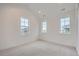 Bright bedroom with carpeted floor and three windows at 1885 Hickory Ave, Erie, CO 80516