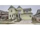 Two-story light green house with a large front porch and attached two-car garage at 1885 Hickory Ave, Erie, CO 80516