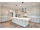 Modern kitchen with island, stainless steel appliances, and light gray cabinets at 1885 Hickory Ave, Erie, CO 80516