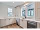 Kitchen features white cabinets, quartz countertops and wine cooler at 1885 Hickory Ave, Erie, CO 80516