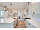 Modern kitchen with white cabinets, large island, and gas cooktop at 1885 Hickory Ave, Erie, CO 80516