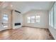 Spacious living room with hardwood floors, fireplace, and large windows at 1885 Hickory Ave, Erie, CO 80516