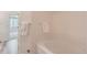 Bright bathroom features a soaking tub, white tile, and convenient access to bedroom at 4222 S Blackhawk Cir # 6G, Aurora, CO 80014