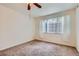 Comfortable bedroom with plush carpeting and a large window for natural light at 4222 S Blackhawk Cir # 6G, Aurora, CO 80014