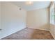 Cozy bedroom featuring neutral carpet, a window for natural light, and baseboard trim at 4222 S Blackhawk Cir # 6G, Aurora, CO 80014