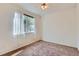 Bedroom featuring a window with sheer curtains and carpet flooring, and a ceiling fan at 4222 S Blackhawk Cir # 6G, Aurora, CO 80014