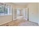 Bright bedroom with carpeted floor, ceiling fan, and French doors to room with large windows at 4222 S Blackhawk Cir # 6G, Aurora, CO 80014