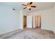 Spacious bedroom with neutral carpet and ceiling fan, featuring access to other rooms at 4222 S Blackhawk Cir # 6G, Aurora, CO 80014