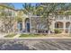 Charming townhome featuring a stone facade, blue door, covered balcony, and well-maintained landscaping at 4222 S Blackhawk Cir # 6G, Aurora, CO 80014
