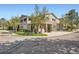Beautiful exterior view of a tan two-story townhome with a stone facade and mature landscaping at 4222 S Blackhawk Cir # 6G, Aurora, CO 80014