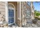 Close up of the front door, blue screen door, and stone facade of the townhome at 4222 S Blackhawk Cir # 6G, Aurora, CO 80014