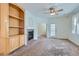 Spacious living room with plush carpeting, built-in shelving, fireplace, and natural light at 4222 S Blackhawk Cir # 6G, Aurora, CO 80014