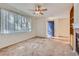 Bright living room boasts carpeting, a blue entry door, a ceiling fan, and a fireplace at 4222 S Blackhawk Cir # 6G, Aurora, CO 80014