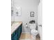 Simple bathroom with blue vanity, neutral walls, and standard fixtures and finishes at 7700 Bison Ct, Littleton, CO 80125
