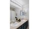 Bathroom with double sinks, large mirror, and modern lighting at 7700 Bison Ct, Littleton, CO 80125
