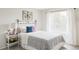 Bright bedroom with butterfly wall art and sheer curtains at 7700 Bison Ct, Littleton, CO 80125