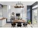 Bright dining area with fireplace, modern lighting, and view into the living room at 7700 Bison Ct, Littleton, CO 80125