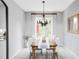 Cozy dining room featuring a wooden table, comfortable seating, and large windows at 7700 Bison Ct, Littleton, CO 80125