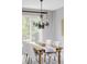Bright dining room with a wooden table, chandelier, and views of the outdoors at 7700 Bison Ct, Littleton, CO 80125